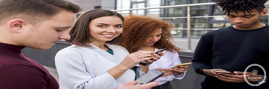 pretty-young-woman-standing-her-friends-using-mobile-phones-looking-camera