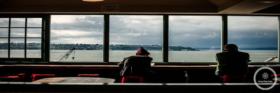 rear-view-men-sitting-by-window-restaurant