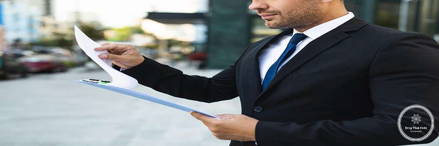 side-view-business-man-reading-from-clipboard