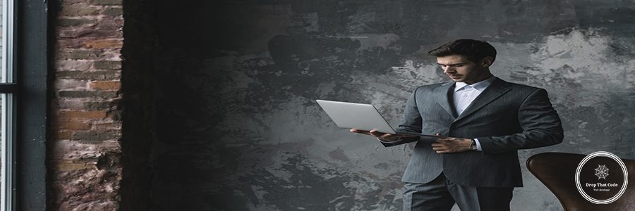 stylish-young-businessman-looking-laptop-his-hand