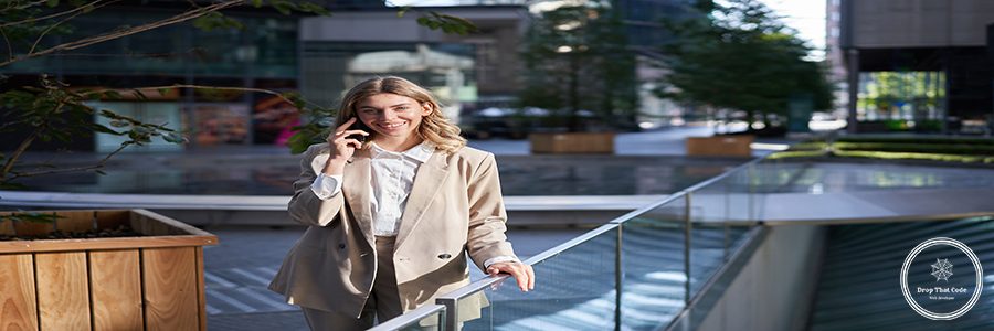 Successful businesswoman talking on mobile phone with confident smile, dealing with business calls, standing on street in city.