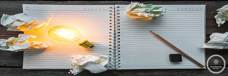 Note book and light bulb on wood table
