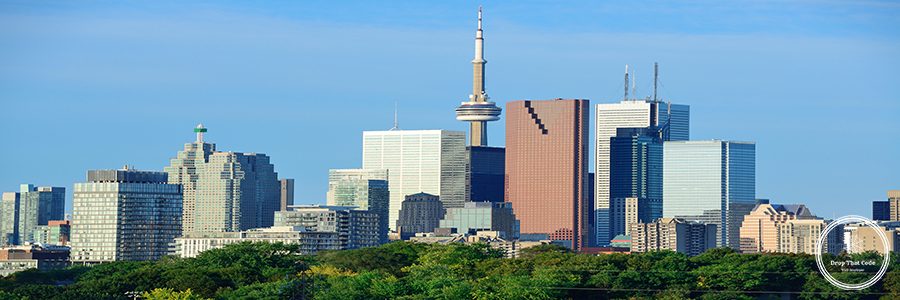 Toronto skyline over park with urban buildings and blue sky