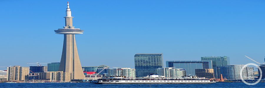 Toronto skyline in the day over lake with urban architecture.