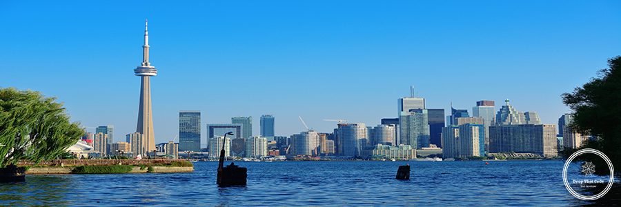 Toronto skyline in the day over lake with urban architecture viewed from park