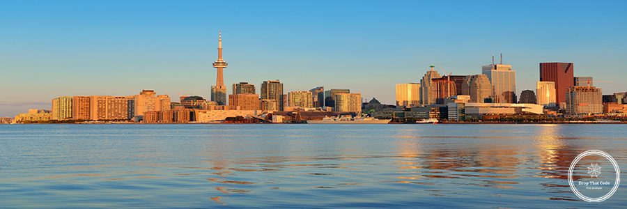 Toronto sunrise with sunlight reflection over lake in the morning