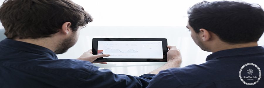 unrecognizable-men-looking-graph-tablet