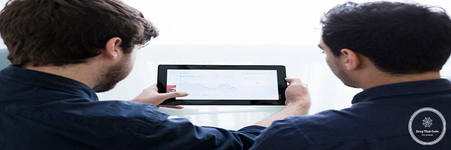 unrecognizable-men-looking-graph-tablet