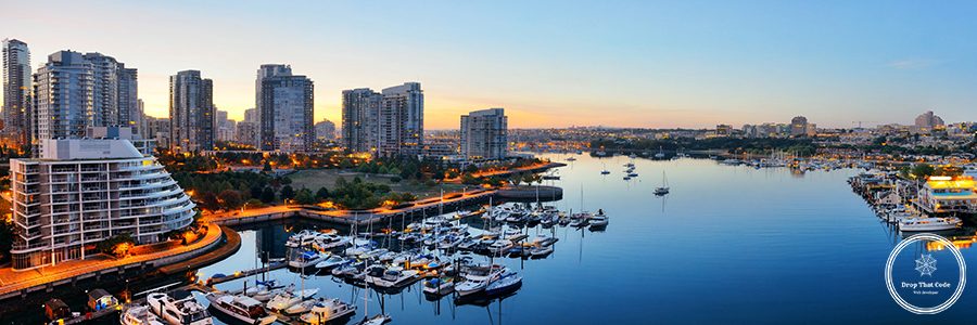 Vancouver harbor view with urban apartment buildings and bay boat in Canada.