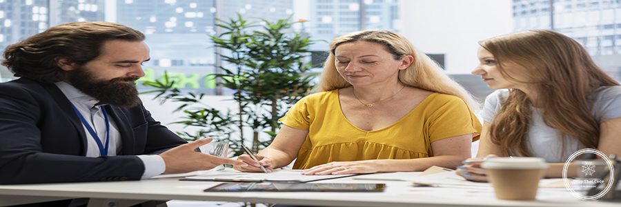 Mother signing contract in office after discussing with consultant and deciding to invest in daughter education. Financial advisor assisting woman filling forms for her child student loan