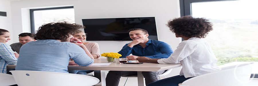 Multiethnic startup business team on meeting in modern bright office interior brainstorming, working on laptop and tablet computer