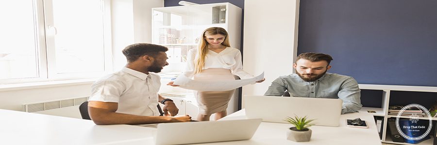 woman-with-draft-near-working-colleagues