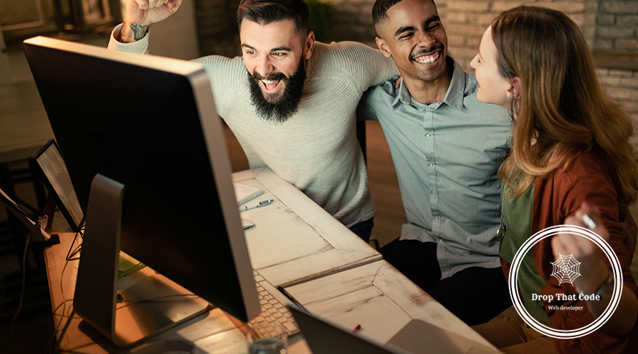 young-startup-team-celebrating-business-success-while-using-computer-office