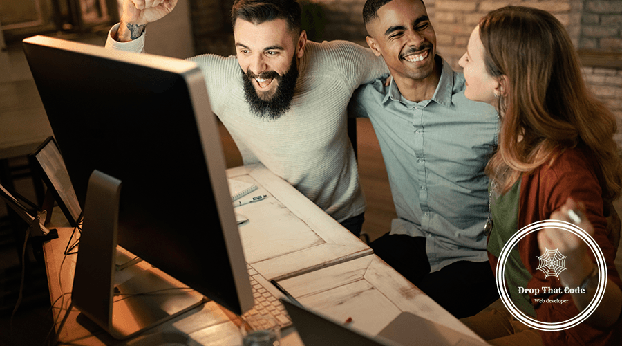 young-startup-team-celebrating-business-success-while-using-computer-office