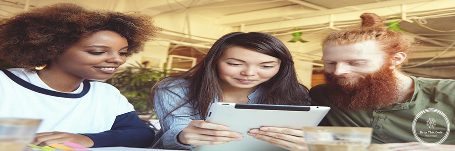 Team, cooperation and creativity. Young entrepreneurs of diverse races using tablet for work on business strategy of their startup project, looking at screen with inspired happy face expression